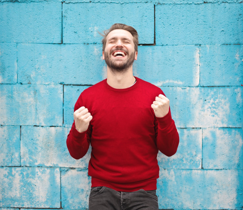 Blonde man smiling and happy with clear aligners.