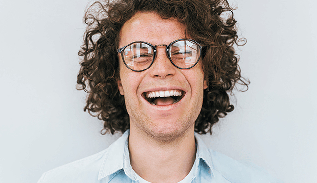 man with glasses smiling