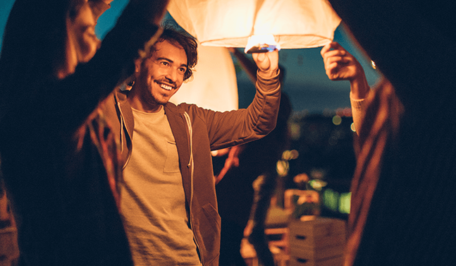 man releasing lantern