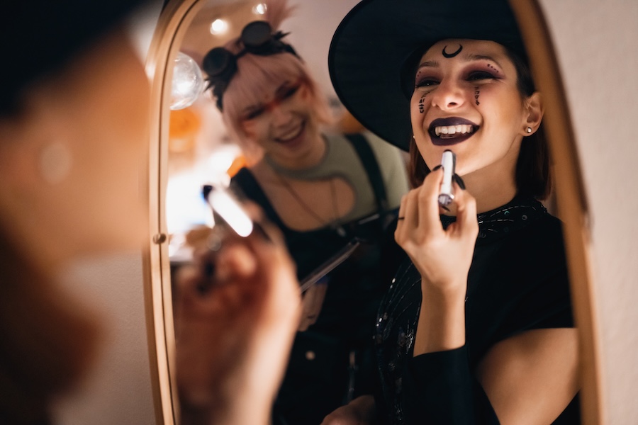 woman smiling in halloween costume considering cosmetic dentistry
