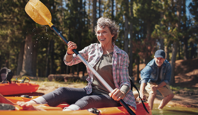 woman smiling while kayaking