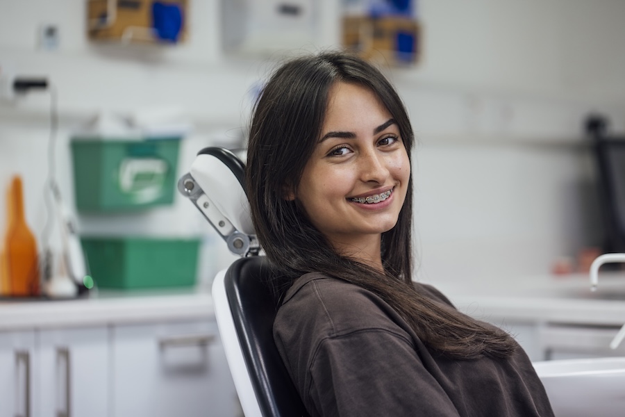 teen in dental chair with braces