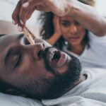 man snoring while partner puts clothespin on nose, sleep apnea